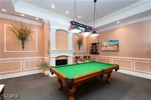 a room with pool table and windows