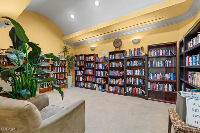 a living room with furniture and a book shelf