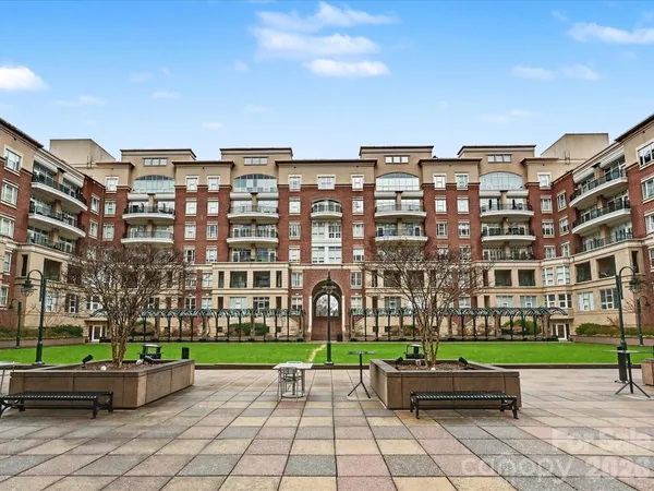 a view of a big building with a yard