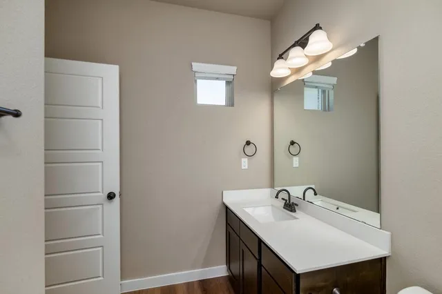 a bathroom with a sink mirror and vanity