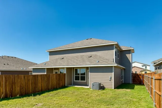 a view of a house with a backyard