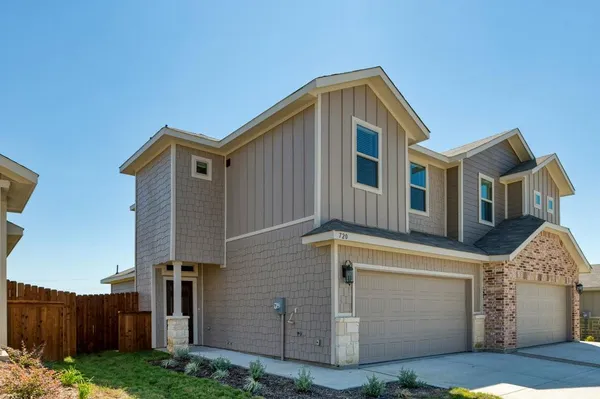 a front view of a house with yard
