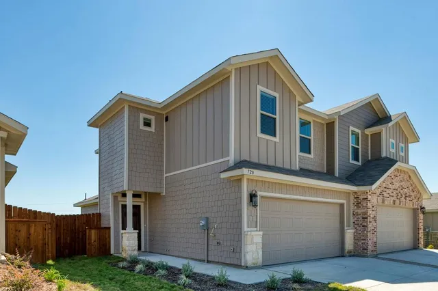 a front view of a house with yard