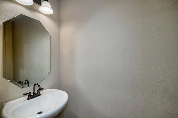 a bathroom with a sink and mirror