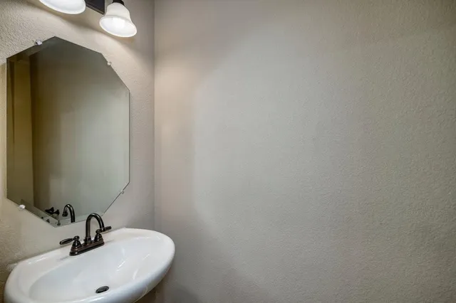 a bathroom with a sink and mirror