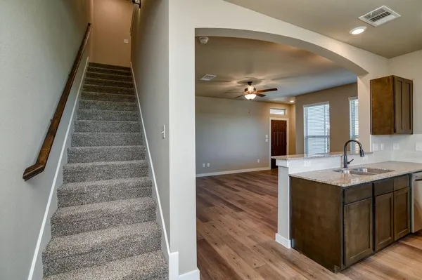 a view of entryway and hall with wooden floor