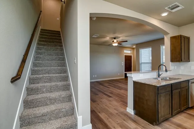 a view of entryway and hall with wooden floor