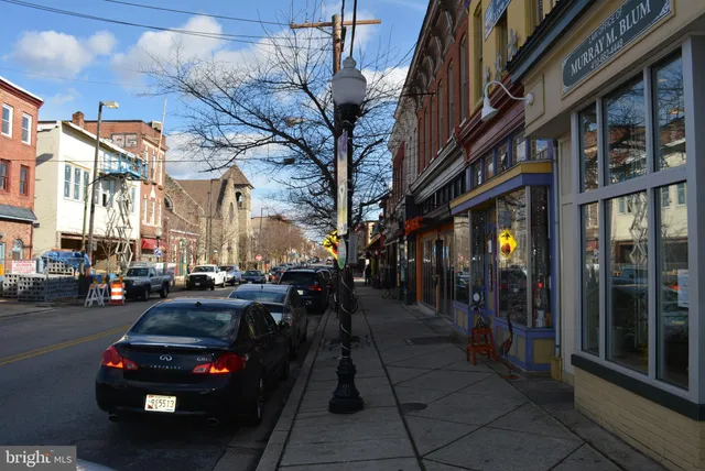 a city street lined with buildings and cars parked on the street