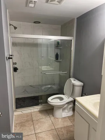 a bathroom with a toilet and a shower