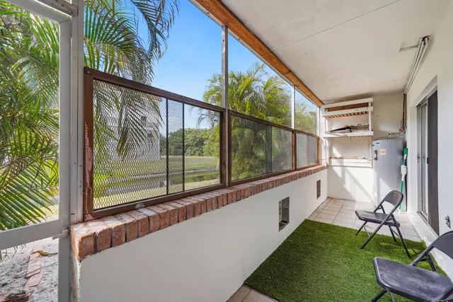 a view of a house with pool and chairs
