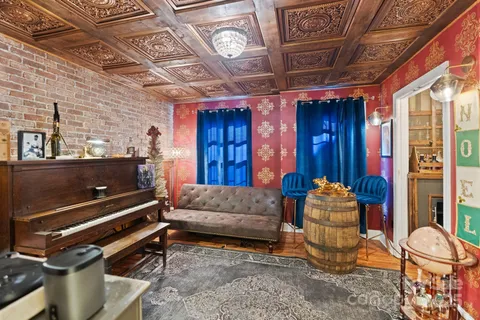 a living room with furniture gym equipment and a chandelier