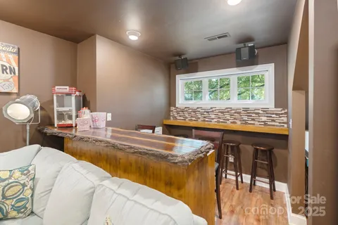 a living room with furniture wooden floor and a flat screen tv