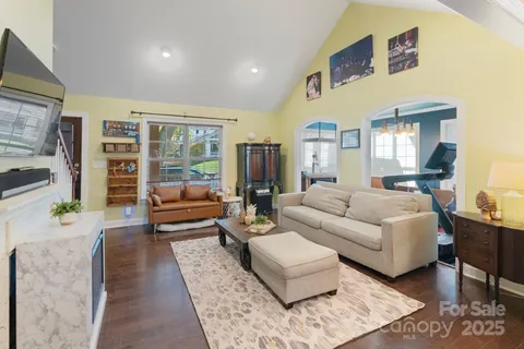 a living room with furniture and wooden floor