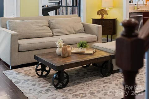a living room with furniture and a chandelier