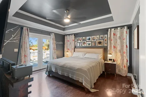a bedroom with a large bed and a chandelier