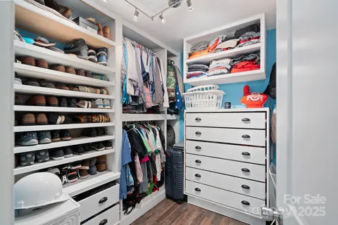 a bedroom with a bed dresser and window