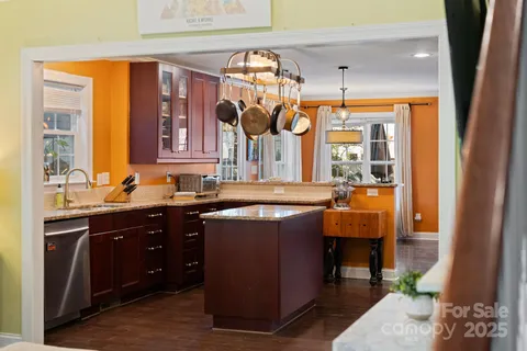 a kitchen with stainless steel appliances granite countertop a sink and cabinets