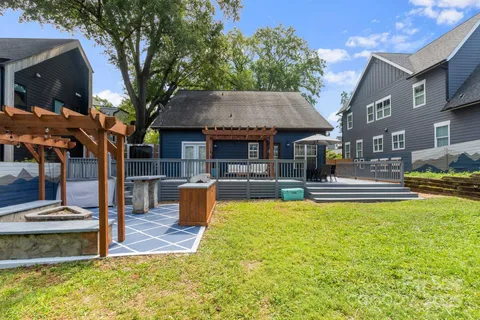 a view of a house with pool and chairs