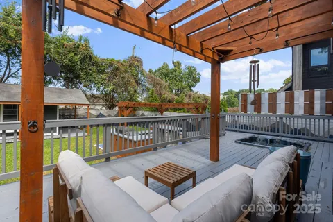 a view of balcony with wooden floor and outdoor seating