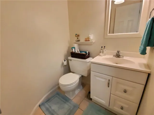 a bathroom with a sink toilet and mirror