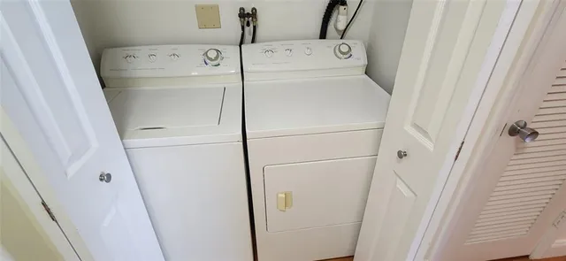 a view of a kitchen with fridge and wooden floor