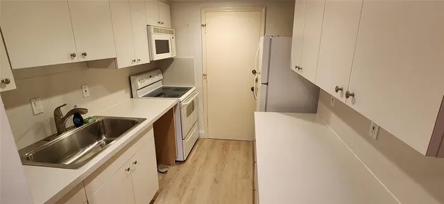 a kitchen with a refrigerator and a sink