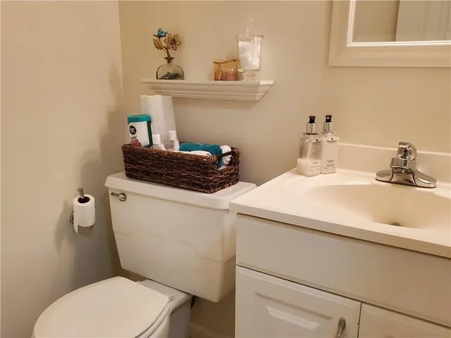 a bathroom with a sink a toilet and a mirror