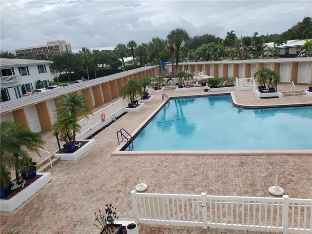 a view of a swimming pool with a lounge chair