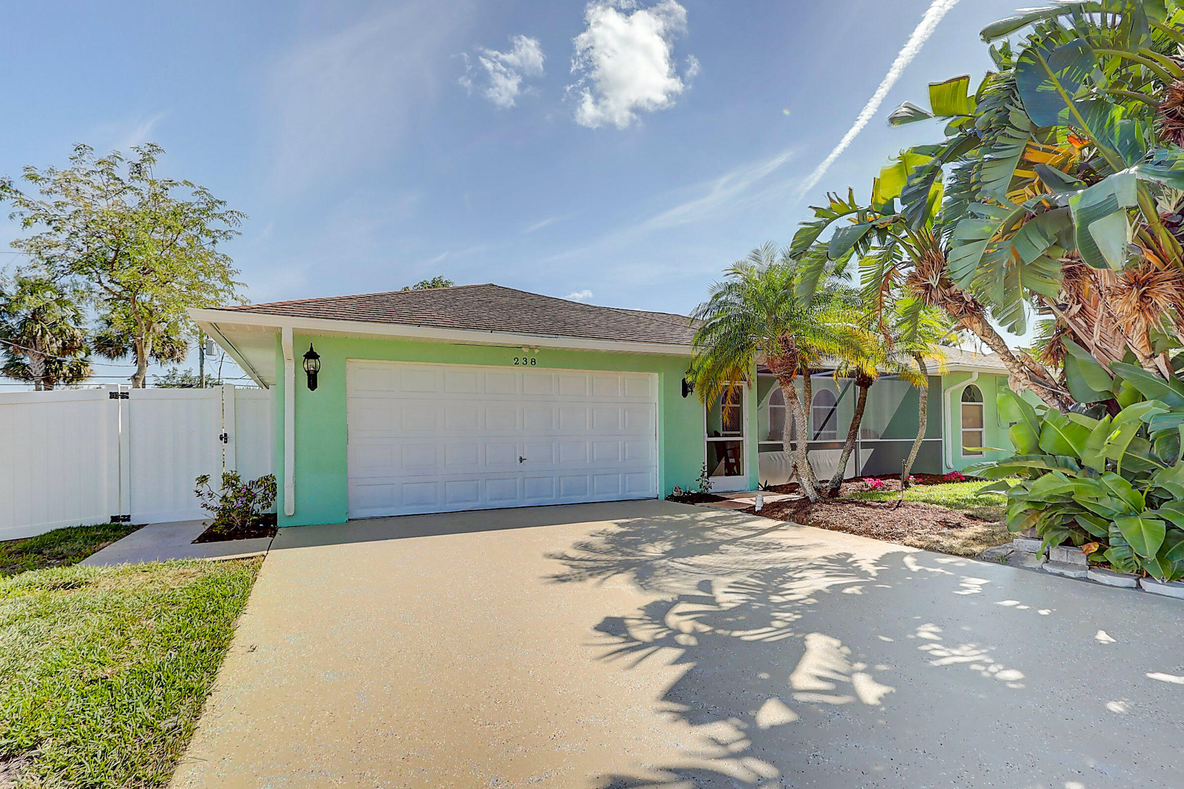 238 Southwest Grove Avenue Port St. Lucie, FL 34983 - Photo 1 of 47 a view of a house with a patio and a yard