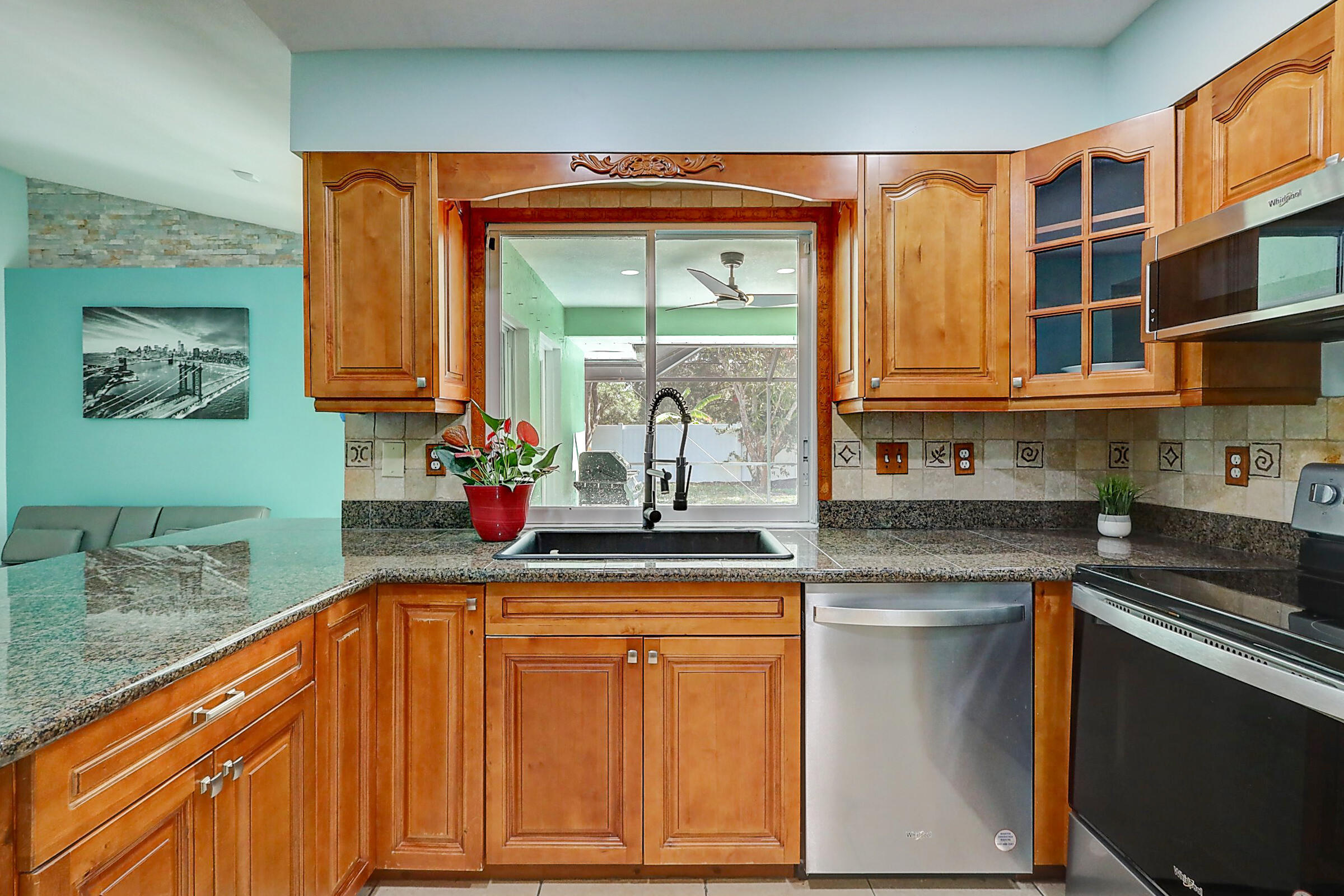 238 Southwest Grove Avenue Port St. Lucie, FL 34983 - Photo 12 of 47 a kitchen with stainless steel appliances granite countertop a sink stove and cabinets
