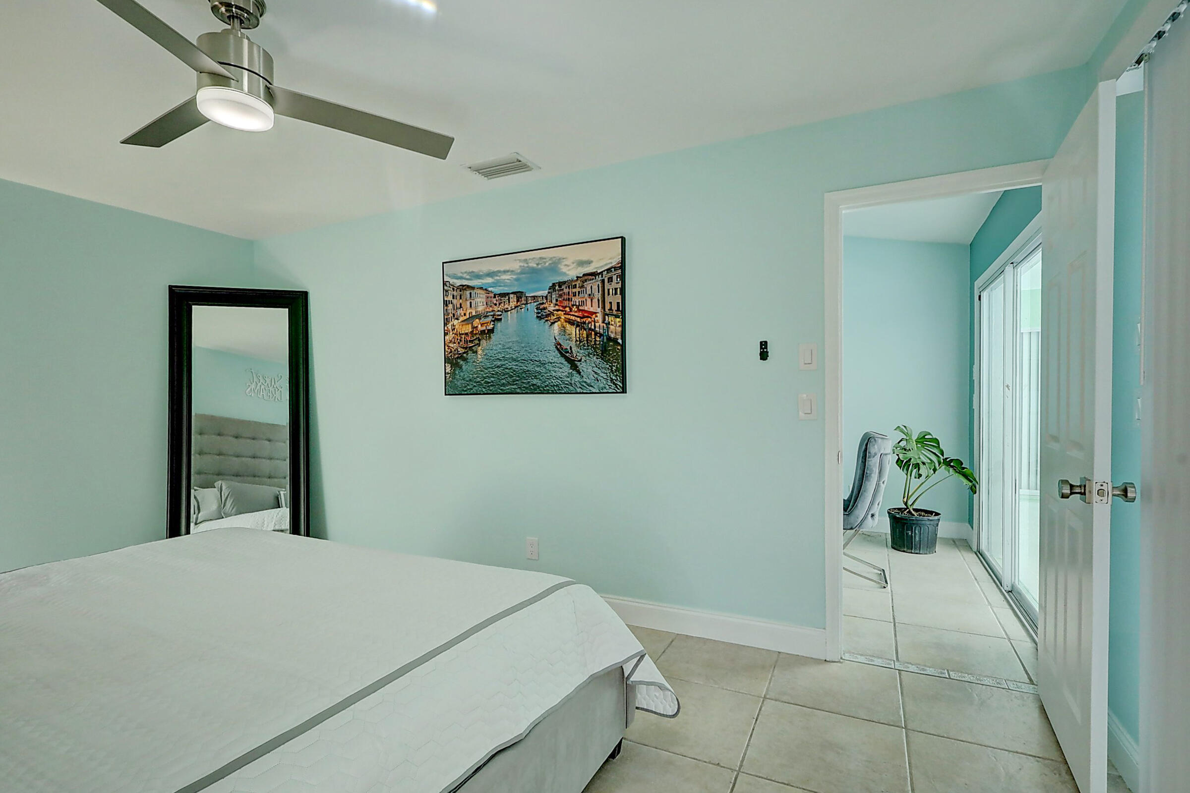 238 Southwest Grove Avenue Port St. Lucie, FL 34983 - Photo 18 of 47 a bedroom with a bed and a painting on the wall