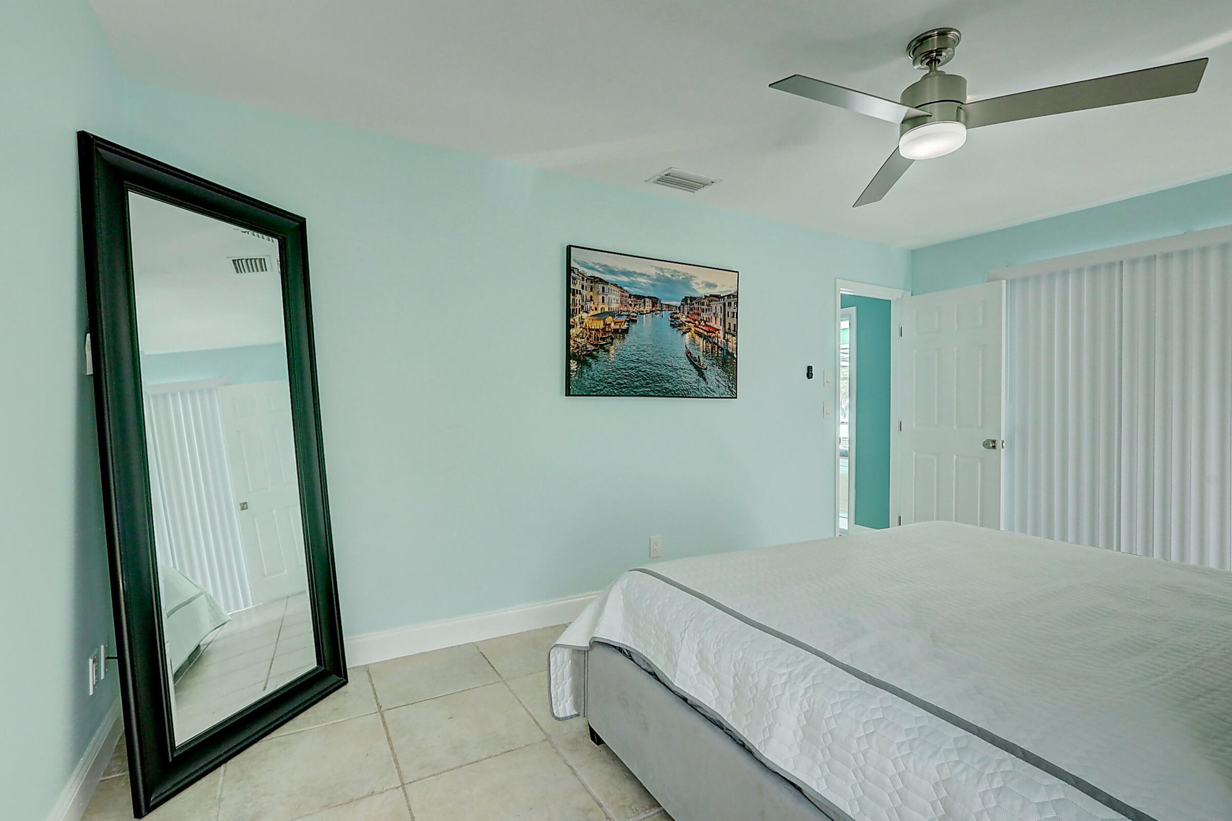 238 Southwest Grove Avenue Port St. Lucie, FL 34983 - Photo 19 of 47 a bedroom with a bed and a painting on the wall