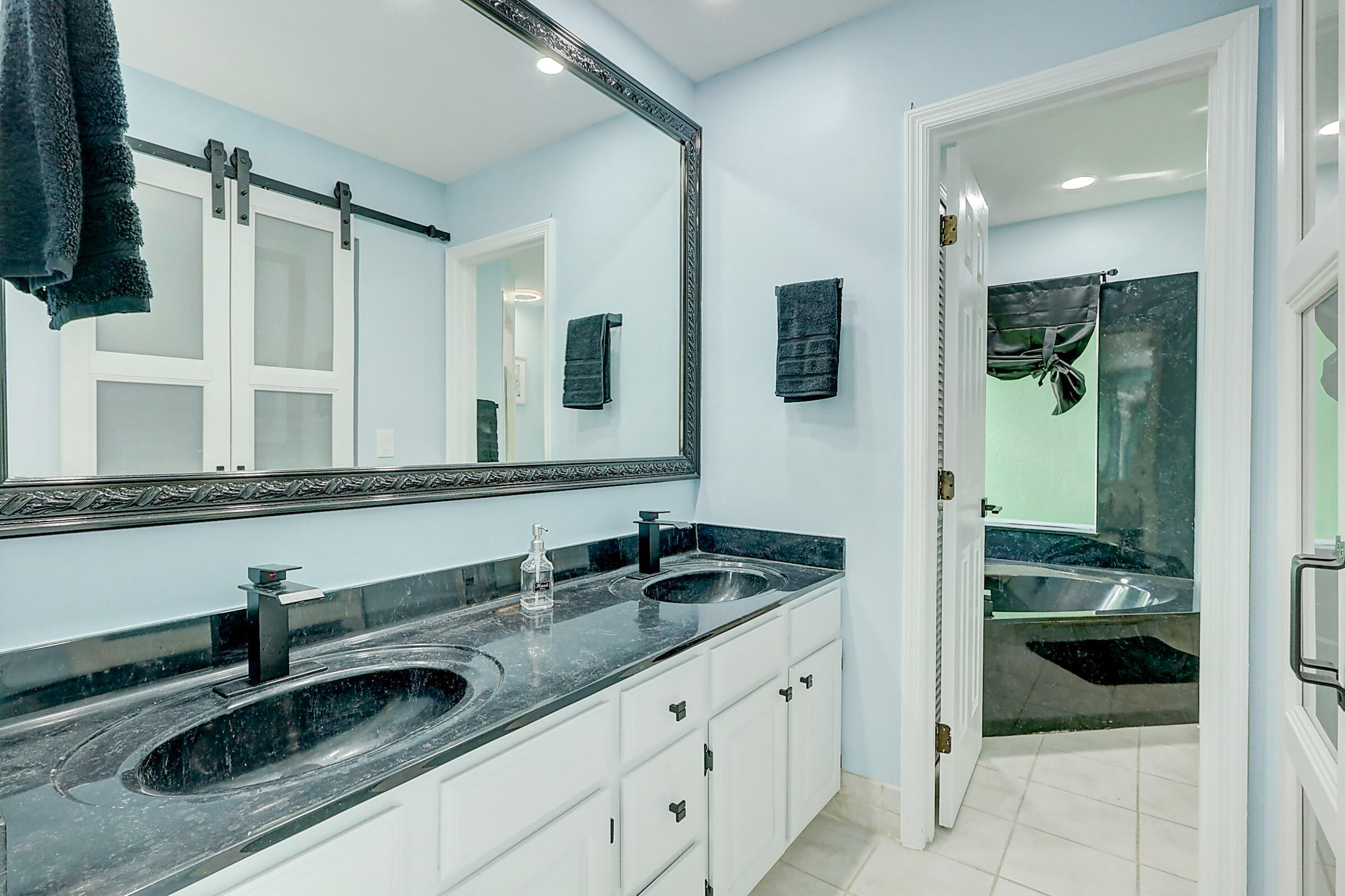 238 Southwest Grove Avenue Port St. Lucie, FL 34983 - Photo 21 of 47 a bathroom with a sink and a mirror
