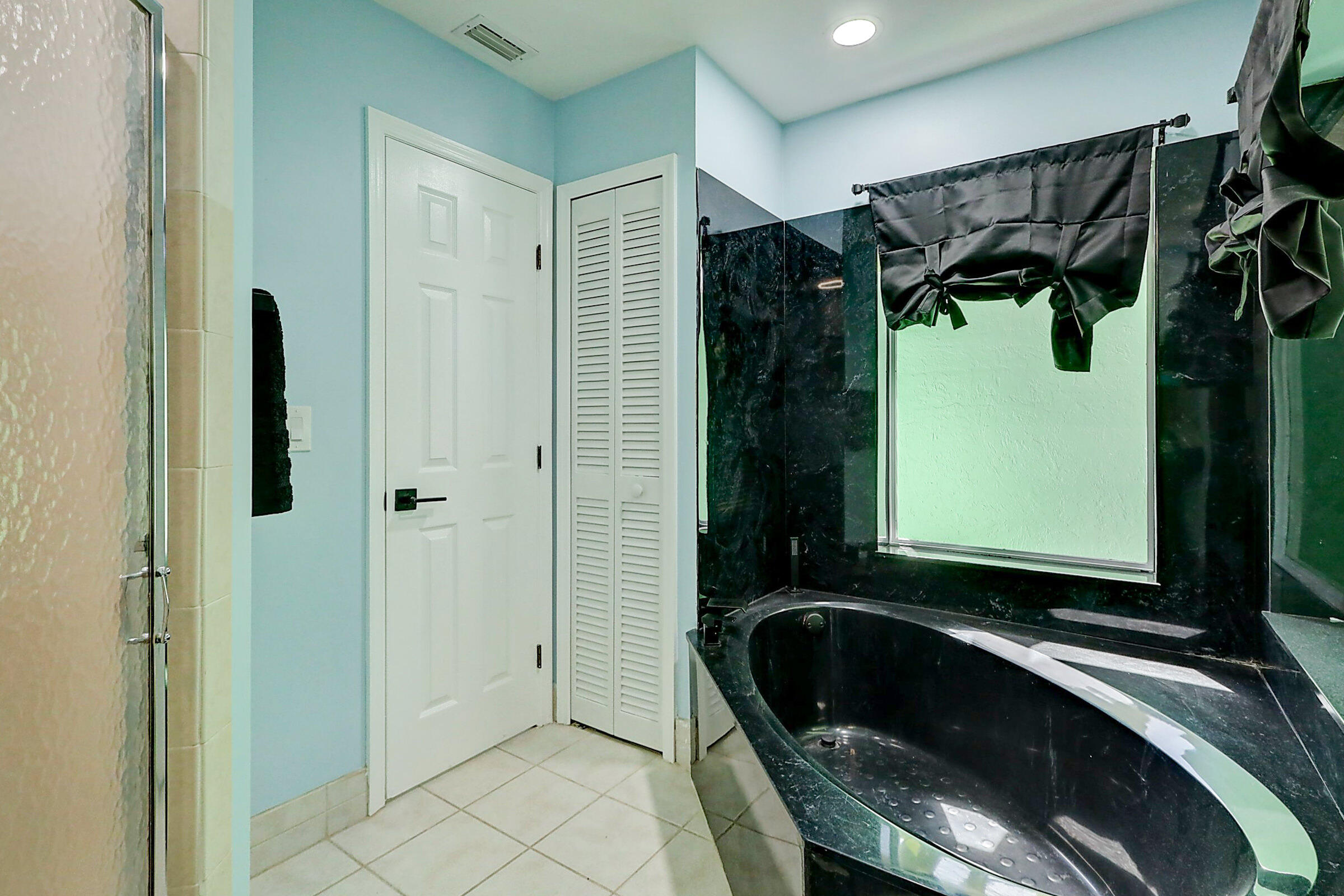 238 Southwest Grove Avenue Port St. Lucie, FL 34983 - Photo 23 of 47 a bathroom with a bathtub and a shower