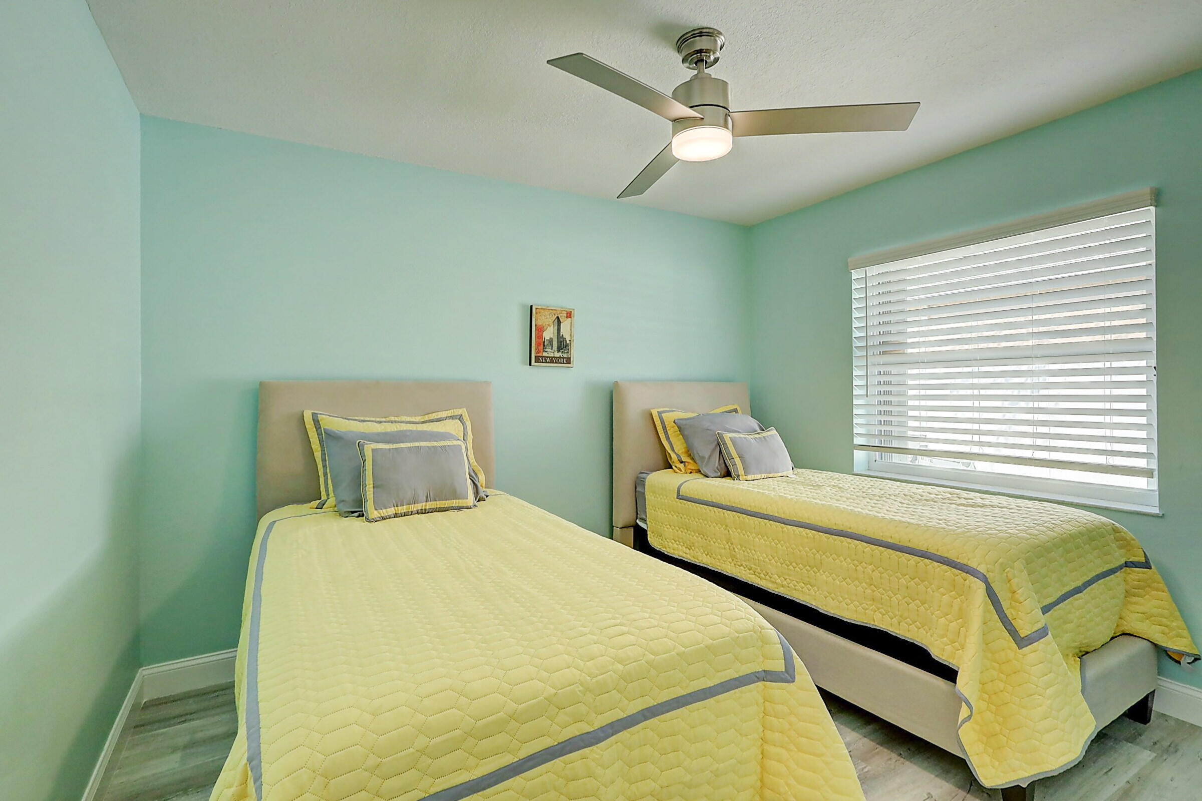 238 Southwest Grove Avenue Port St. Lucie, FL 34983 - Photo 30 of 47 a bedroom with two beds and ceiling fan