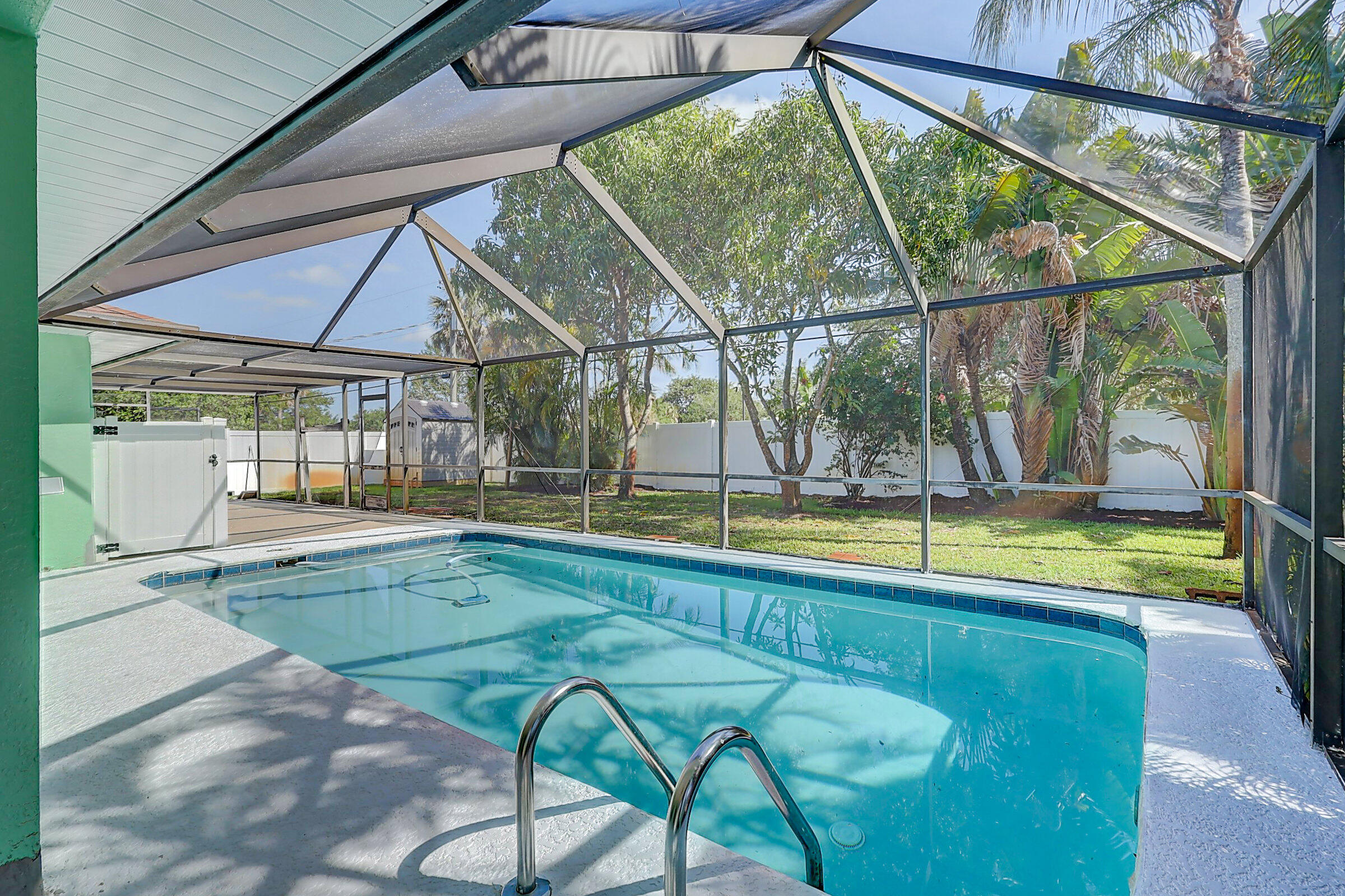 238 Southwest Grove Avenue Port St. Lucie, FL 34983 - Photo 34 of 47 a view of swimming pool with a yard