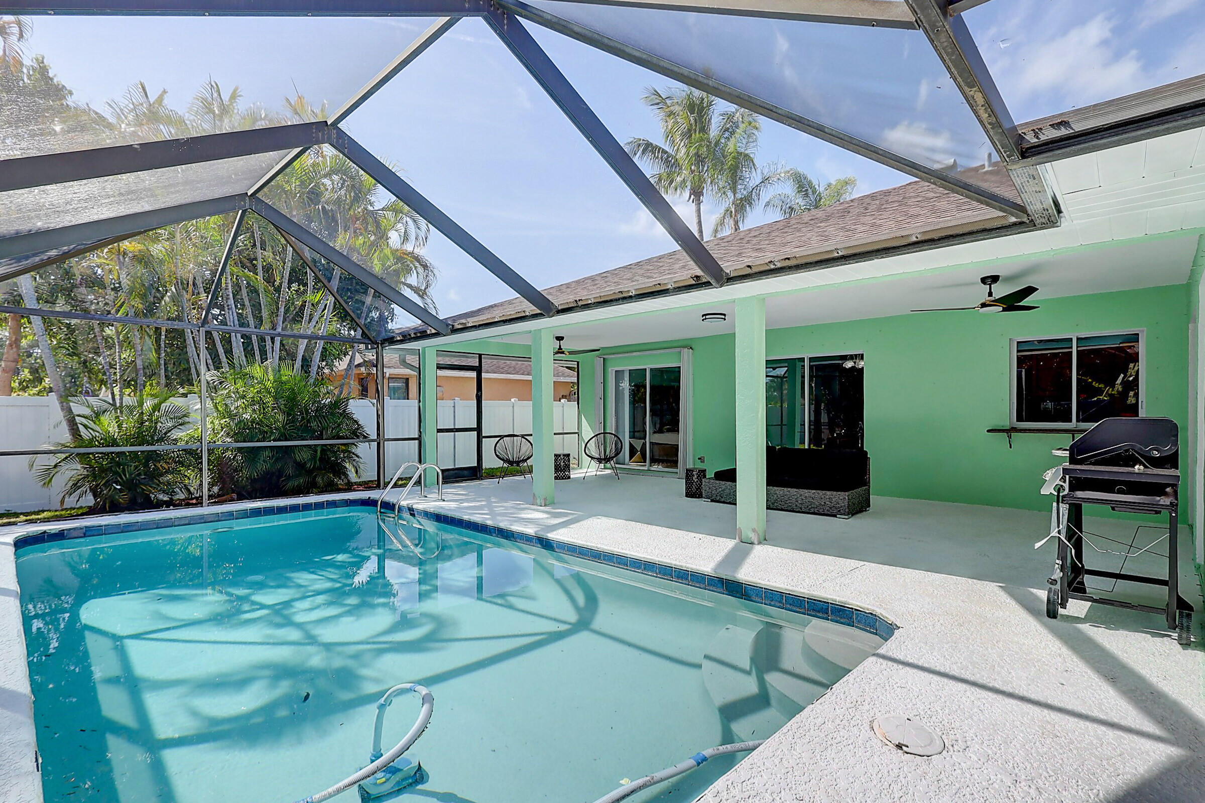 238 Southwest Grove Avenue Port St. Lucie, FL 34983 - Photo 37 of 47 a swimming pool with outdoor seating and yard