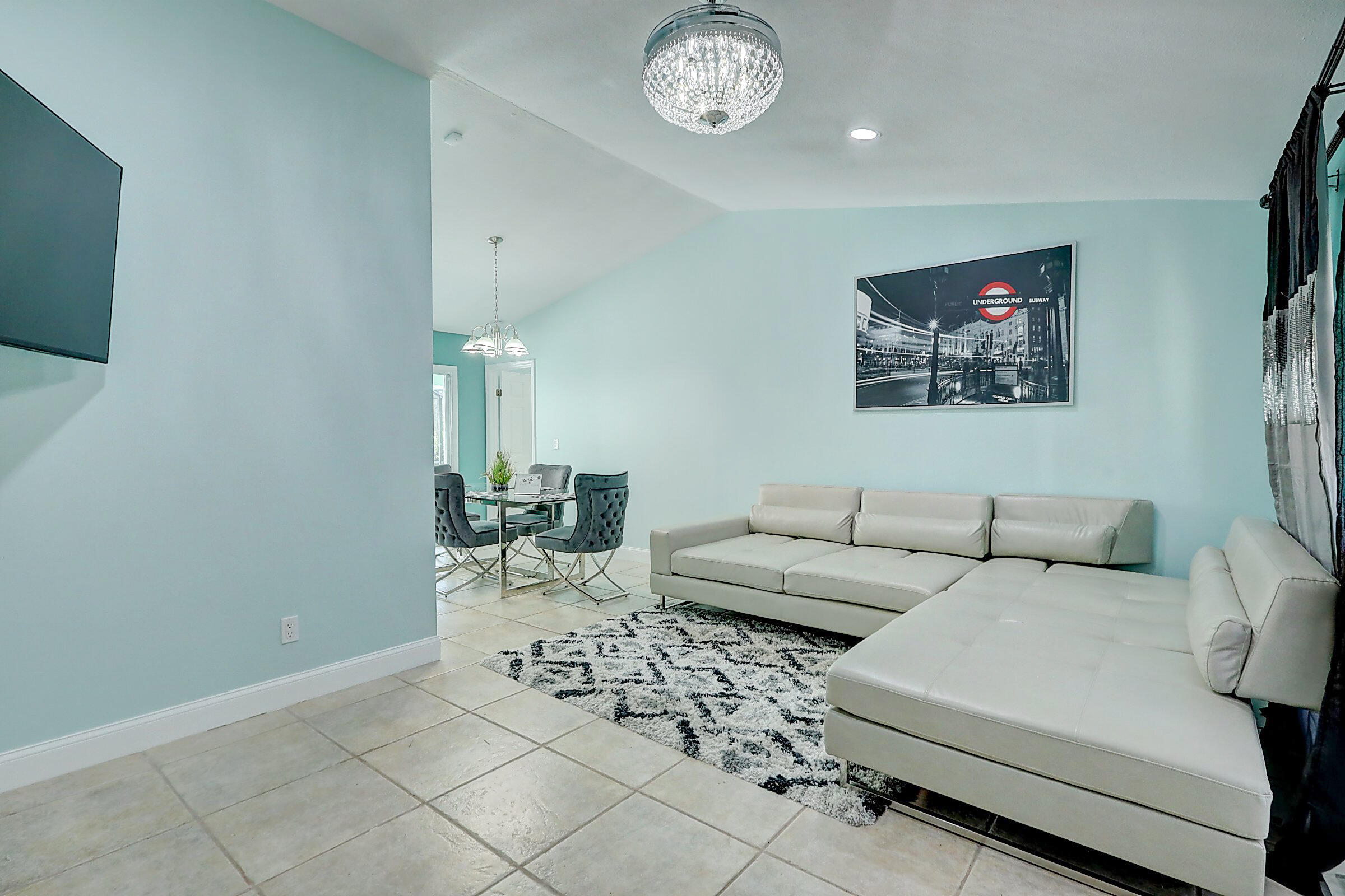 238 Southwest Grove Avenue Port St. Lucie, FL 34983 - Photo 6 of 47 a living room with furniture a clock and a window