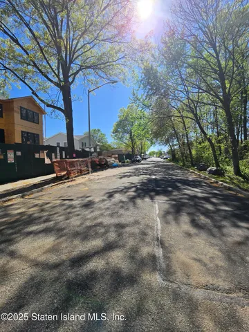 a view of a street with a building in the background