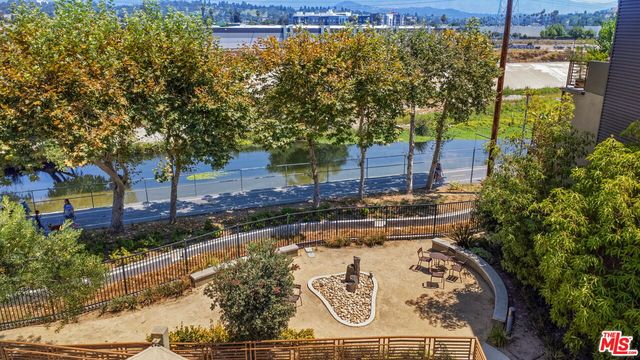 a view of a backyard with plants and a garden