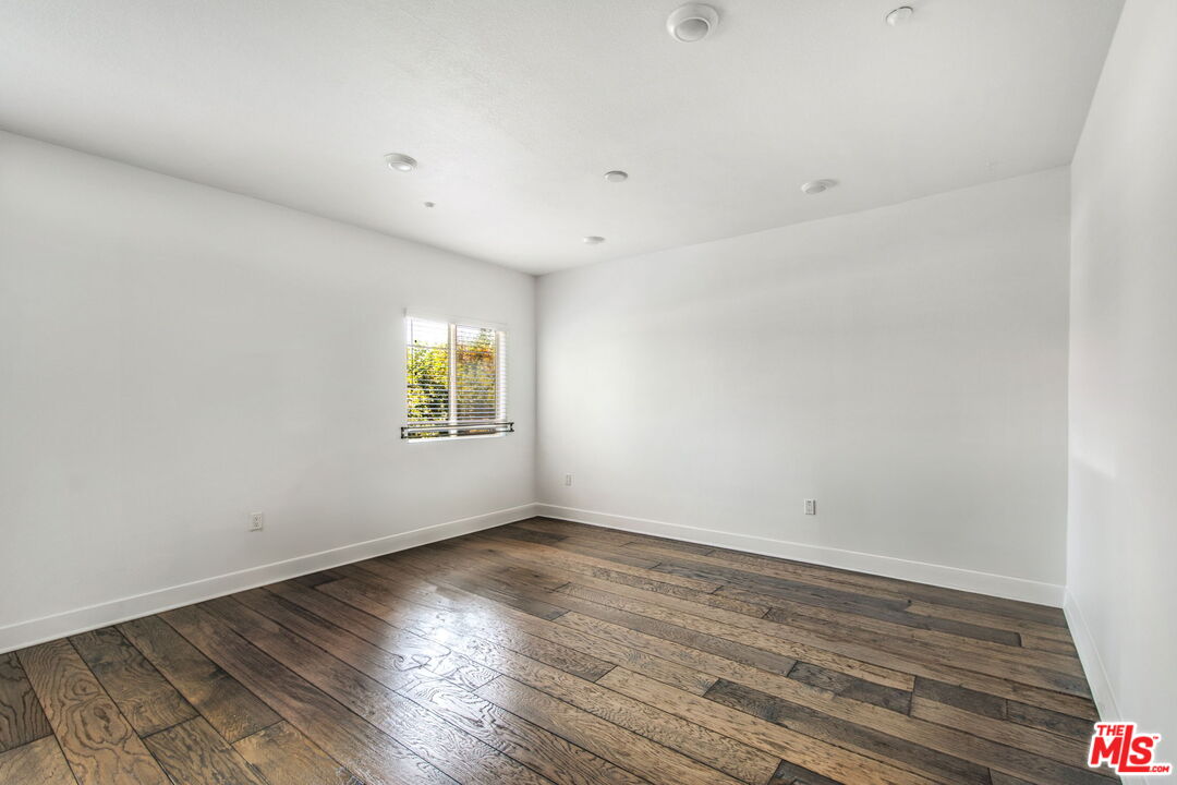 2974 Ripple Place, Unit 203 Los Angeles, CA 90039 - Photo 9 of 29 a view of an empty room with wooden floor and a window