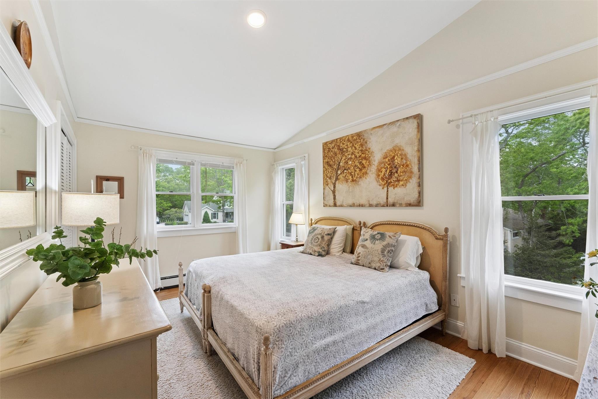 21 Summit Boulevard Westhampton, NY 11977 - Photo 14 of 28 a bedroom with a large bed and a potted plant