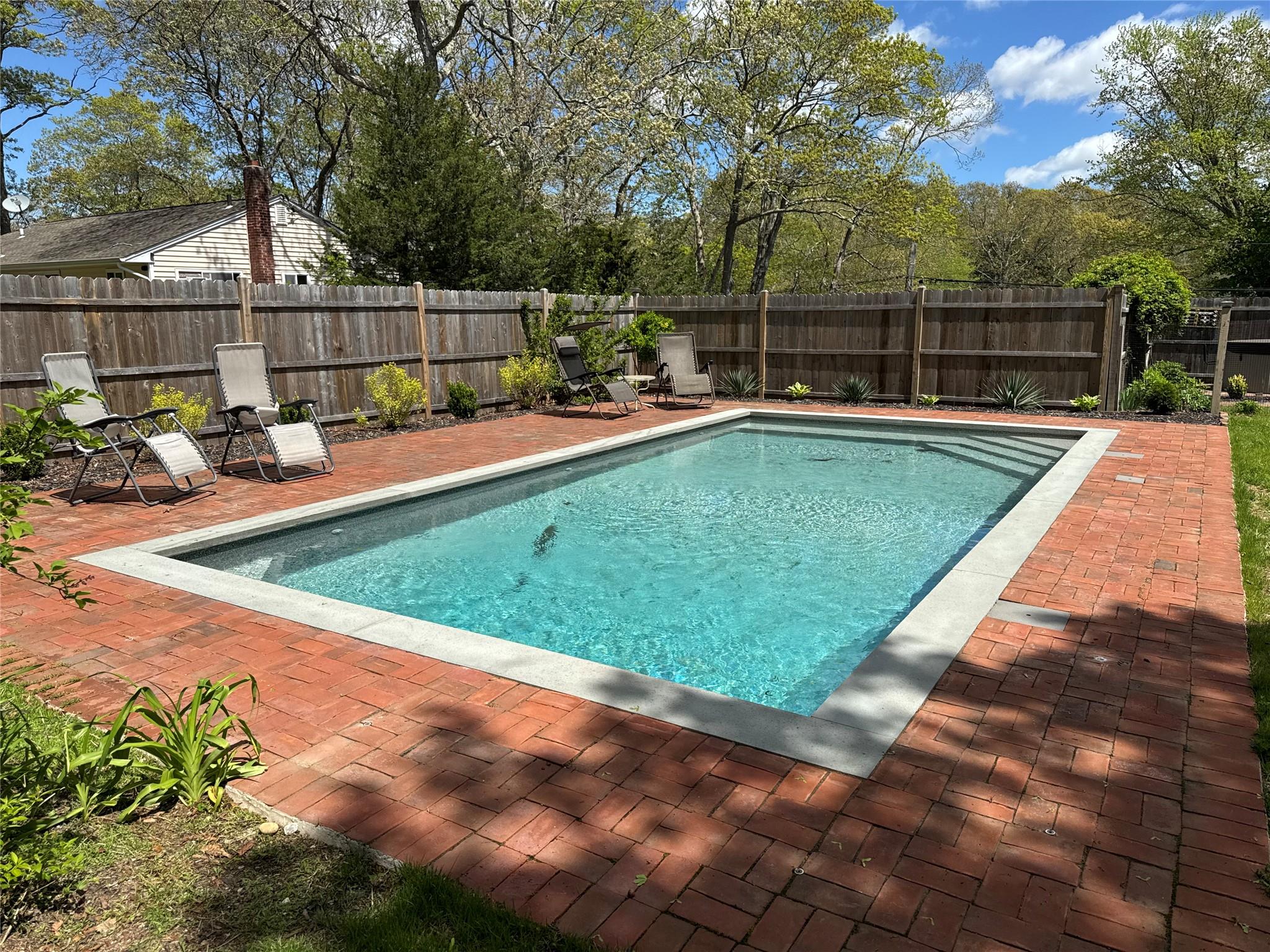21 Summit Boulevard Westhampton, NY 11977 - Photo 2 of 28 a view of a backyard with a patio and swimming pool