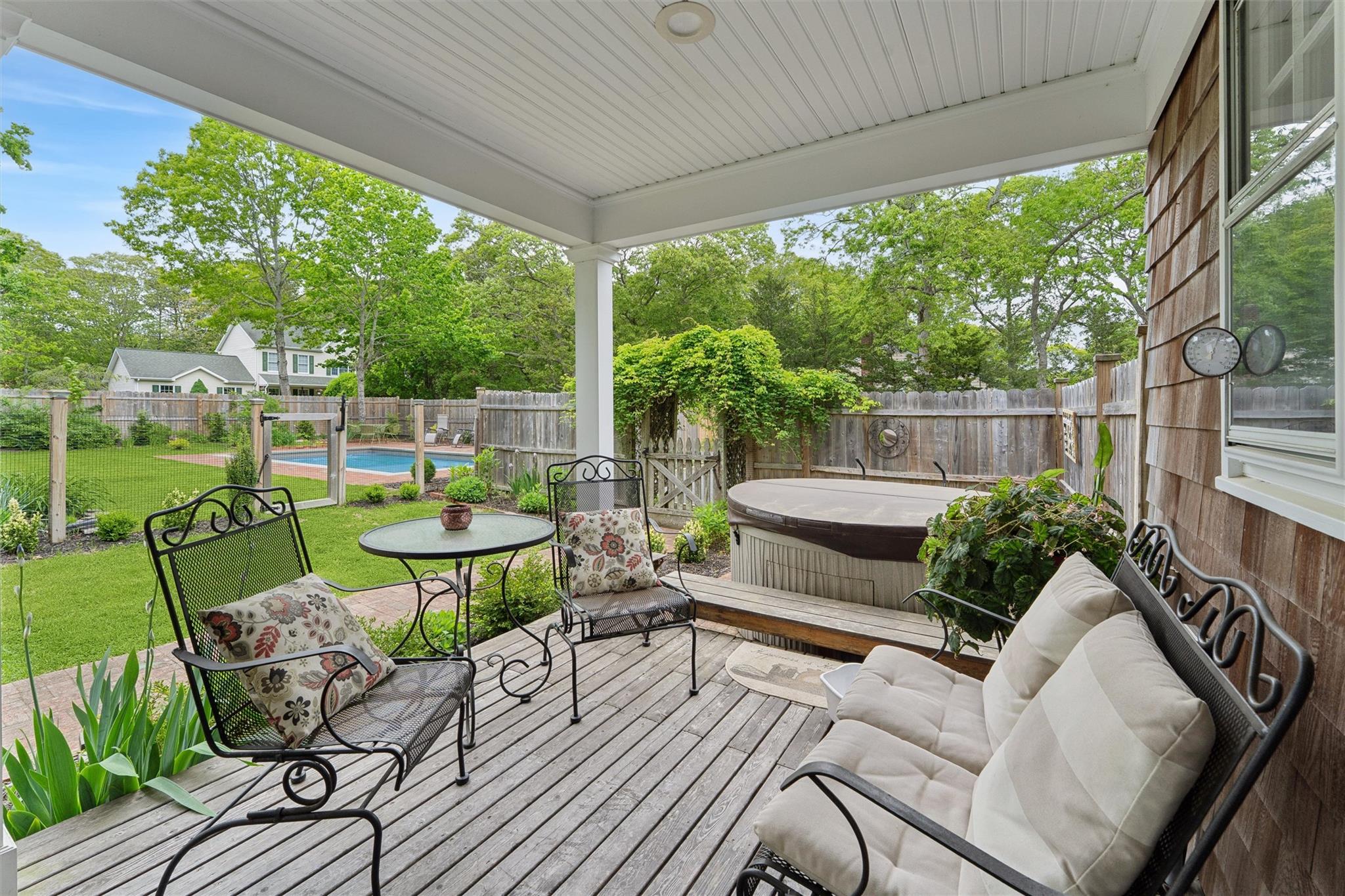 21 Summit Boulevard Westhampton, NY 11977 - Photo 21 of 28 a view of a patio with table and chairs potted plants with floor to ceiling window