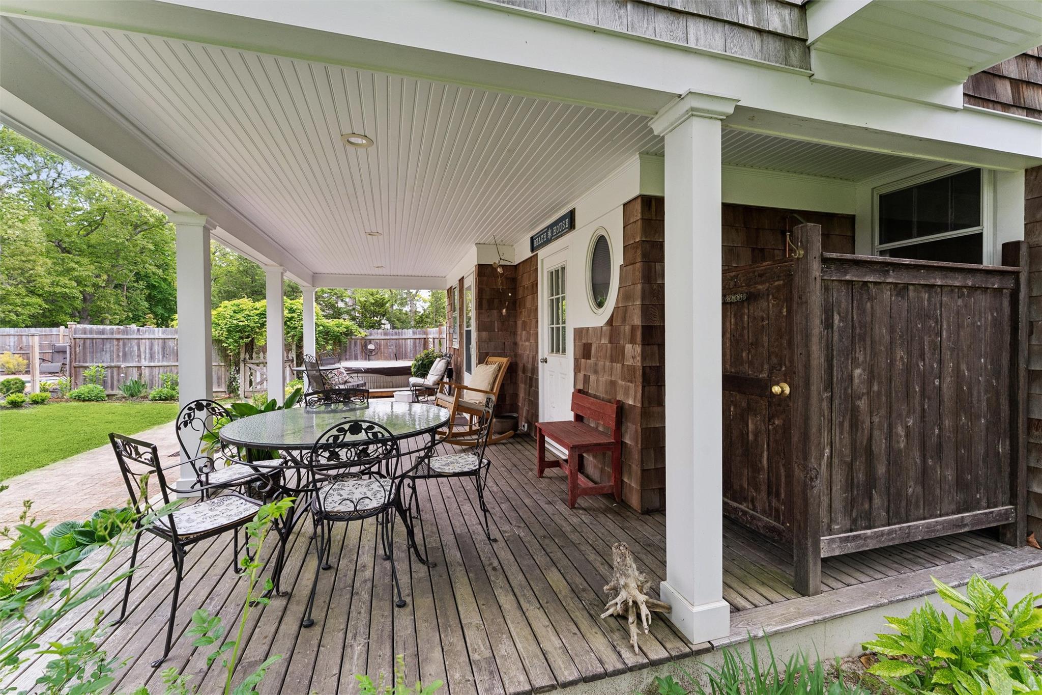 21 Summit Boulevard Westhampton, NY 11977 - Photo 23 of 28 a view of a patio with table and chairs and wooden floor