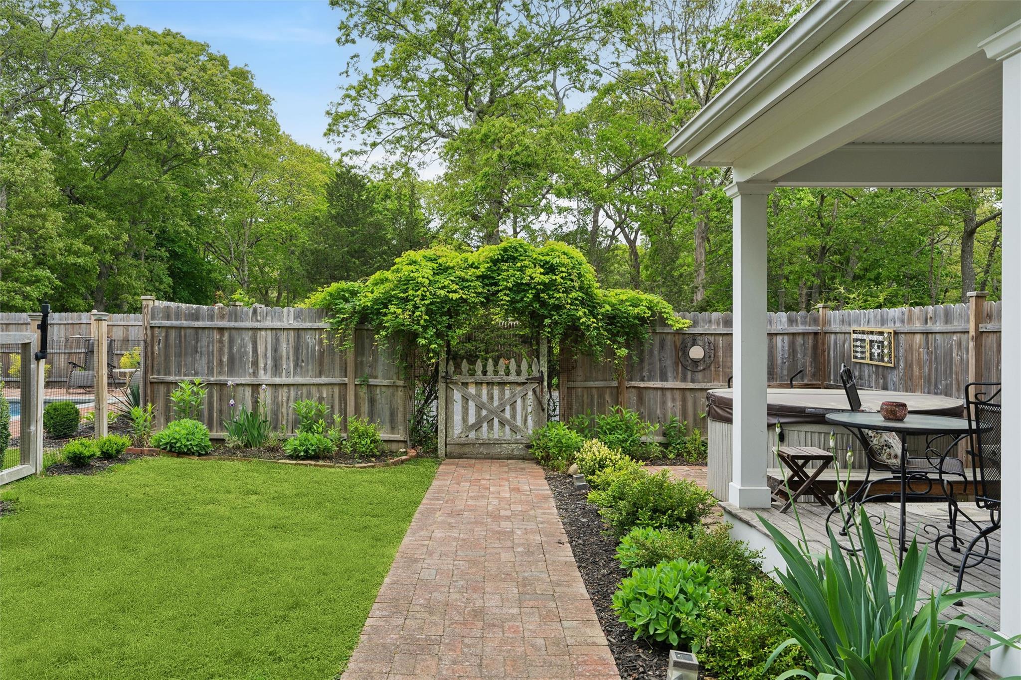 21 Summit Boulevard Westhampton, NY 11977 - Photo 26 of 28 a view of a chair and table in backyard of the house