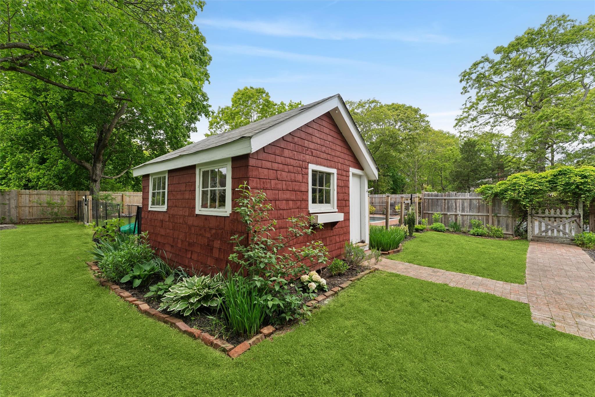 21 Summit Boulevard Westhampton, NY 11977 - Photo 28 of 28 a view of a back yard with plants and a large tree