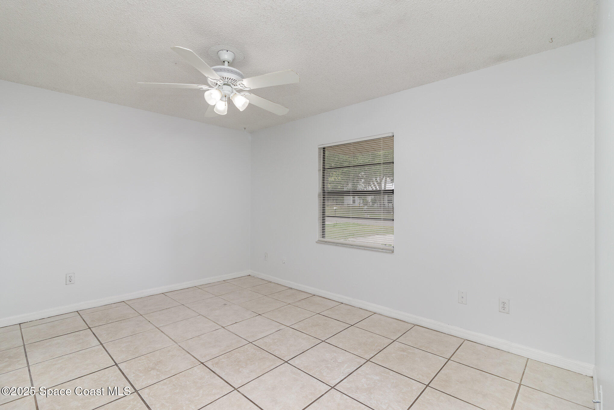 7413 Ester Road Cocoa, FL 32927 - Photo 11 of 30 a view of an empty room with a window