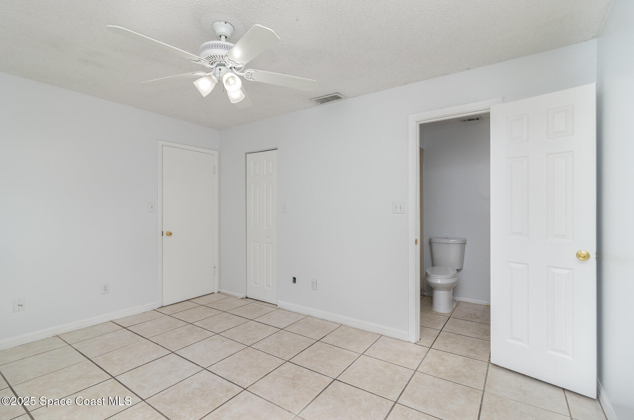 7413 Ester Road Cocoa, FL 32927 - Photo 12 of 30 a view of a room with a chandelier fan and windows