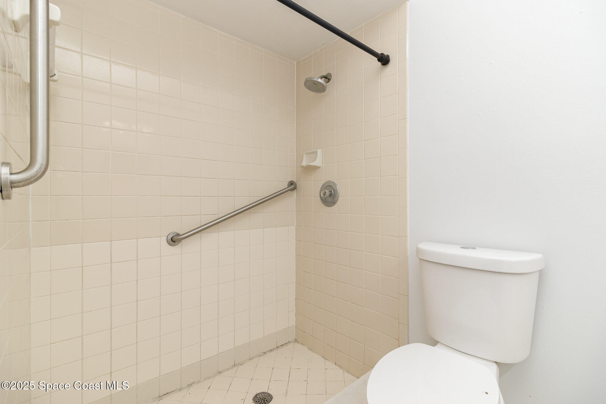 7413 Ester Road Cocoa, FL 32927 - Photo 14 of 30 a white toilet sitting next to a shower